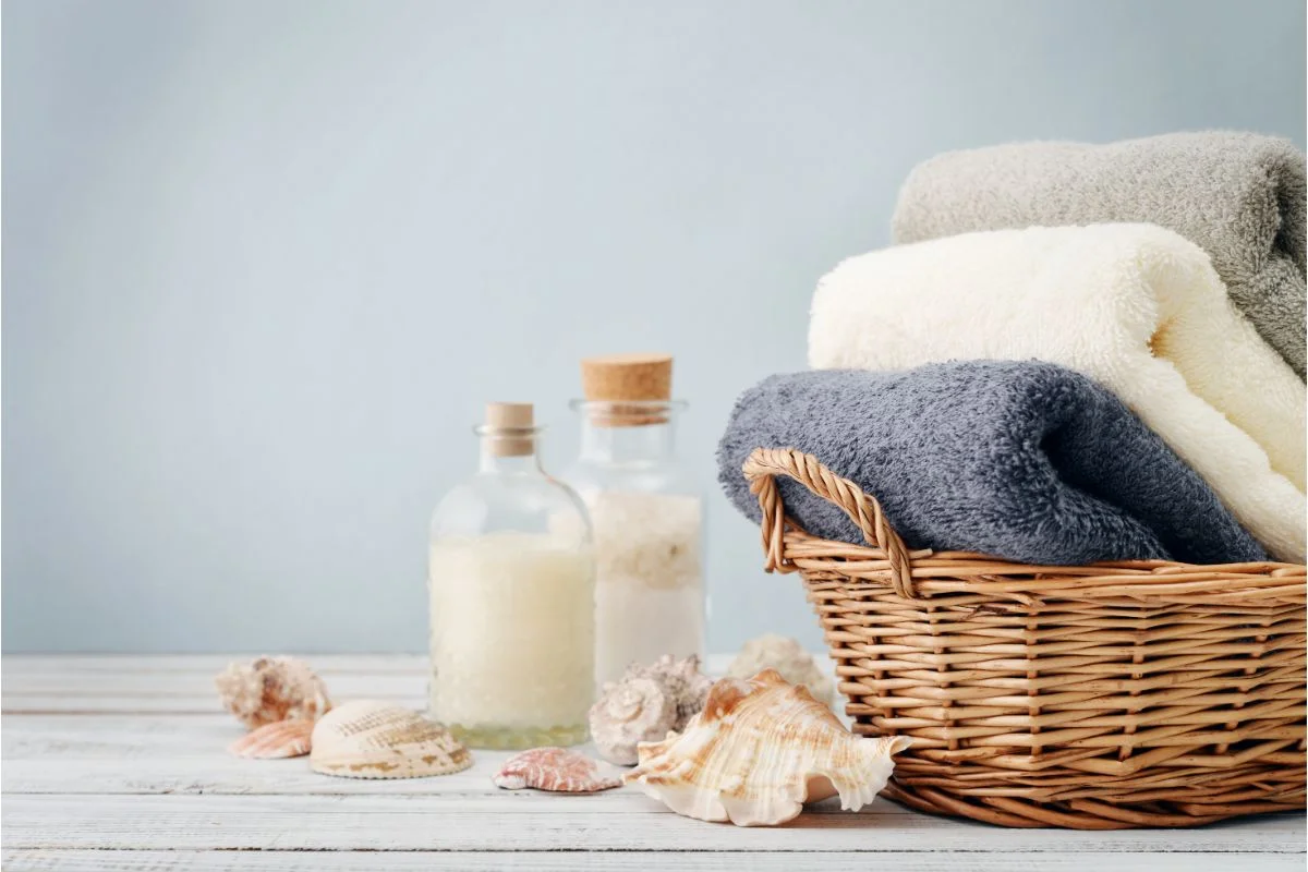 trois serviettes douces et moelleuses dans un panier en osier